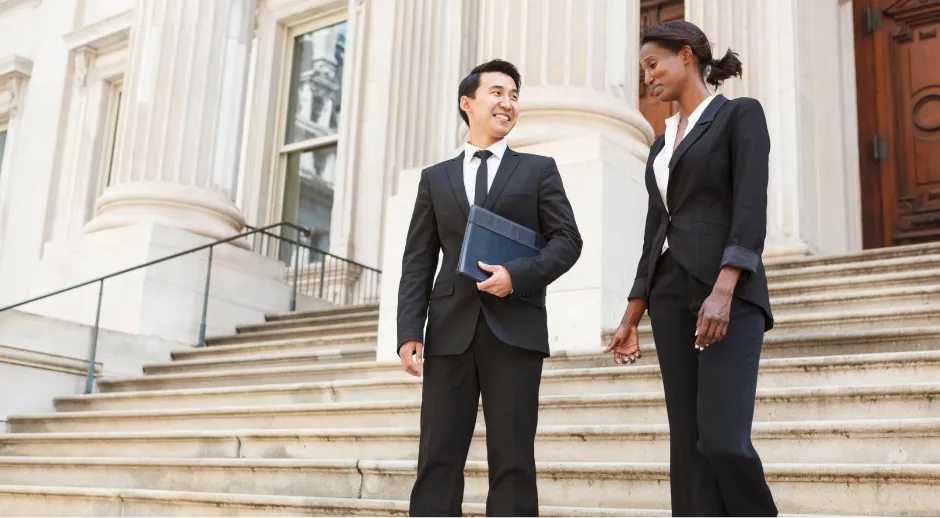 Two attorneys conversing on courthouse steps.