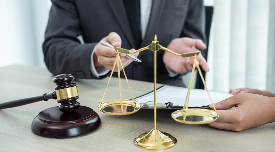 Gavel and scales of justice on a desk during a legal consultation.