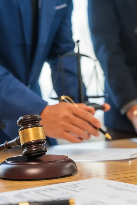 Probate lawyer in California reviewing estate documents beside gavel and justice scales in office